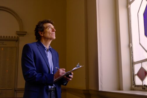 Bradley takes notes inside a synagogue.