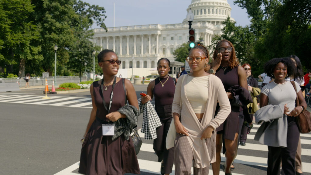 A group of youth advocates walking past the Capitol building